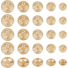 a collection of gold buttons with designs on them