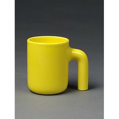 a yellow coffee cup sitting on top of a table