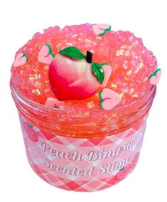 a pink plastic container filled with candy and an apple on the top that says peach bunny scented stuff