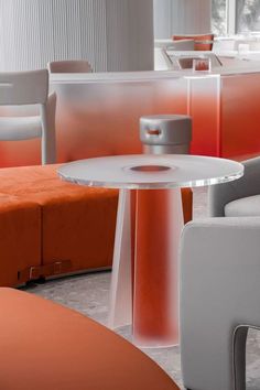 an orange and white room with chairs and tables