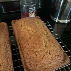 two loafs of bread cooling on a rack