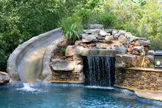 a pool with a waterfall next to it