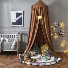 a child's bedroom with a canopy bed and stuffed animals on the wooden floor