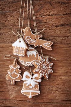 gingerbread christmas ornaments hanging on a wooden table