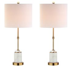 a pair of white and gold table lamps with shades on each lamp, one is turned off