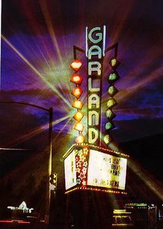 the marquee sign is lit up at night