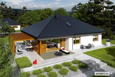 an aerial view of a small house with a patio and covered in grass, surrounded by trees