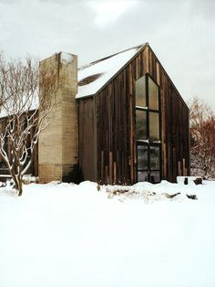 an old barn in the middle of winter with snow on the ground