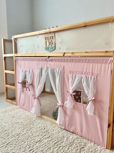 a bunk bed with curtains on the top and bottom