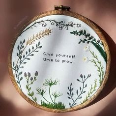 a hand embroidered hoop with the words give yourself time to grow on it