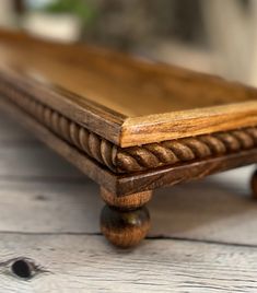 a wooden bench sitting on top of a white table