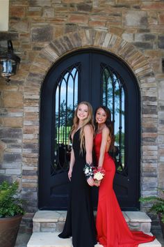 two young women in formal wear posing for the camera