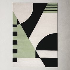 a black, white and green rug in a room