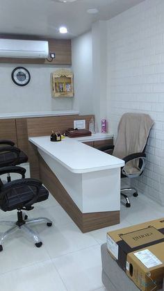 an office with two chairs, a desk and a box on the floor in front of it