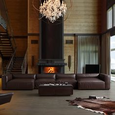 a living room with a large couch and a fire place in the middle of it