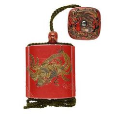 a red box with a dragon design on it and a rope attached to the front