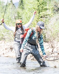 two women fly fishing in the river together