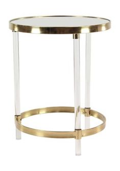 a gold and clear glass side table with two metal bars on the bottom, against a white background