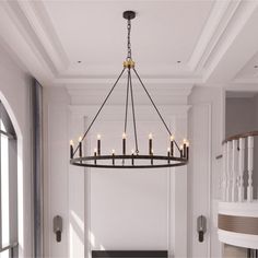 a chandelier hanging from the ceiling in a room with white walls and flooring