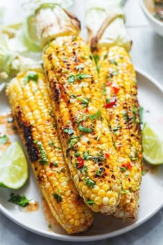 grilled corn on the cob with lime wedges and cilantro sauce