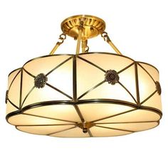 a semi - flush ceiling light fixture with an art deco design and white glass shades