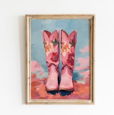 a painting of pink cowboy boots with flowers on them