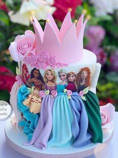 there is a cake with princesses on it