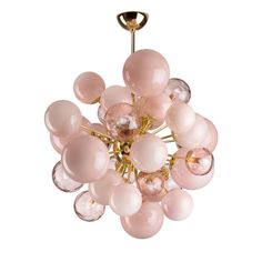 a chandelier with pink glass balls hanging from it's golden metal frame