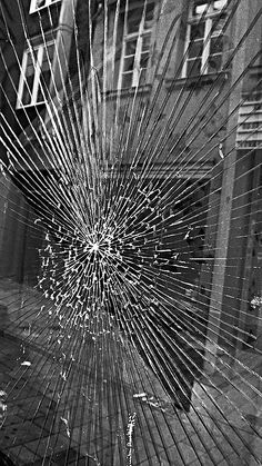 a broken glass window on the side of a building