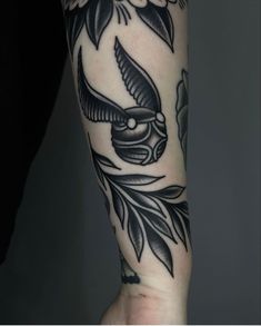 a person's arm with tattoos on it and an eagle in the middle of the arm