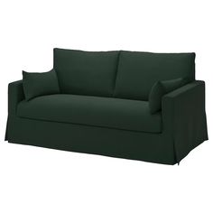 a green couch with two pillows on it's back and one arm facing the camera