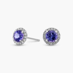 For someone who wants to add a bit of color to a classic style, these vibrant tanzanite and diamond halo earrings are an ideal choice. Crafted in bright 14k white gold, these gemstone stud earrings feature round tanzanite gems surrounded by sparkling halos of micropave diamonds. Their petite size makes them a great everyday jewelry option. Diamond Halo Earrings, Halo Diamond Earrings, Precious Gemstones Jewelry, Halo Earrings, Gemstone Stud Earrings, Diamond Stud Earrings, Gemstone Studs, Diamond Stud, Diamond Halo