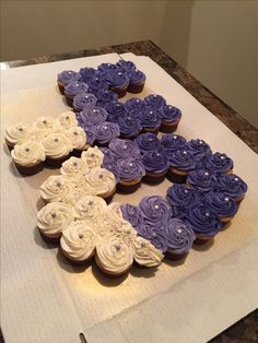 cupcakes are arranged in the shape of an x on a sheet of paper