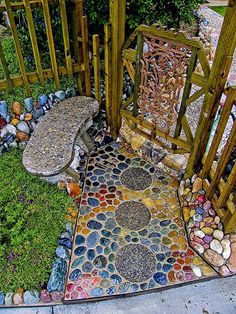 an outdoor area with rocks and grass on the ground, including a bench made out of stones