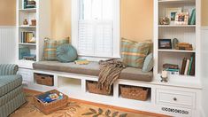 a living room filled with lots of furniture and bookshelves next to a window