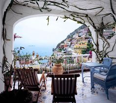 a magazine cover with two chairs and a table in front of a view of the ocean