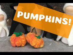 three stuffed animals sitting next to each other in front of a sign that says pumpkins