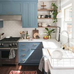 a kitchen with blue cabinets and white counter tops