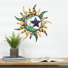 a clock that is on the wall next to a potted plant and an open book