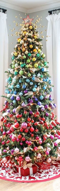 a christmas tree decorated with ornaments and ribbons