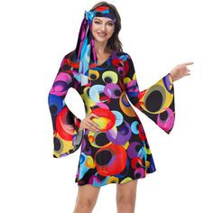 a woman wearing a colorful dress with bell sleeves and an open - front hoodie