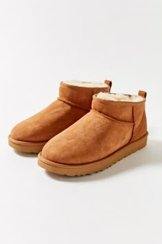 Give feet a break in these luxuriously cozy ankle boots from UGG. Their classic silhouette cut super-mini in a soft suede, pretreated to repel moisture and stains. Lined with a plush Twinface sheepskin fur and fitted on a durable Treadlite by UGG outsole for traction. Nylon binding and overlock stitch on seams.Content + Care. Suede, sheepskin, rubber Spot clean ImportedSize + Fit. True to size Mini Outfit, Ugg Classic Ultra Mini, Ugg Mini, Ugg Classic, Break In, Silhouette Cut, Boots Outfit, Shoe Game, Soft Suede