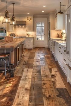 a kitchen filled with lots of wooden floors and white cabinets next to a counter top