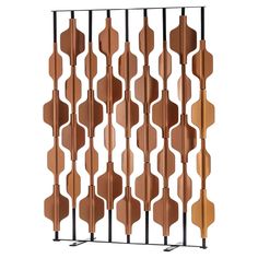 an iron and wood wall divider with geometric designs on it, set against a white background