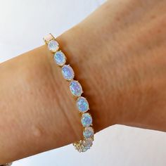 -18kt gold vermeil (sterling silver base) -lab created blue opals -6. 5'' length   Mesmerizing and unique blue opal tennis bracelet made up 18kt gold vermeil (sterling silver base) and beautiful blue opal stones. The bracelet measures 6. 5'' in length. To extend the life of your gold plated and vermeil jewelry, avoid wearing when washing hands, showering, applying lotion, using harsh cleaning supplies or working out. To clean, buff gently with a soft and dry 100% cotton cloth or a microfiber cloth. Do not use jewelry cleaner on gold plated jewelry. Opal Tennis Bracelet, Jewel Design, September Birthstone Jewelry, Jewelry Lookbook, Vermeil Jewelry, Pearl Jewellery Earrings, Jewelry Ring Box, Men's Jewelry Rings, Evil Eye Jewelry