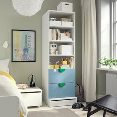 a white and blue bookcase in a bedroom