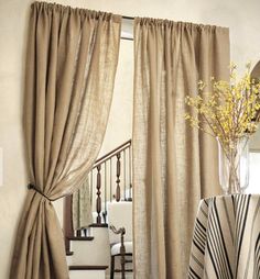 a living room filled with furniture and curtains