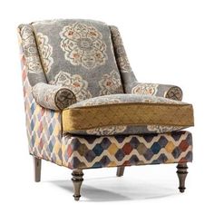 an upholstered chair with patterned fabric and wooden legs