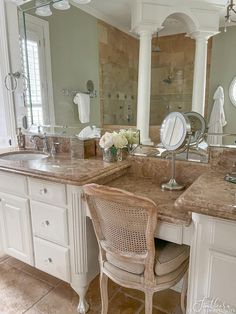 a bathroom with two sinks and a chair in front of the mirror on the wall