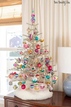 a white christmas tree with ornaments on it